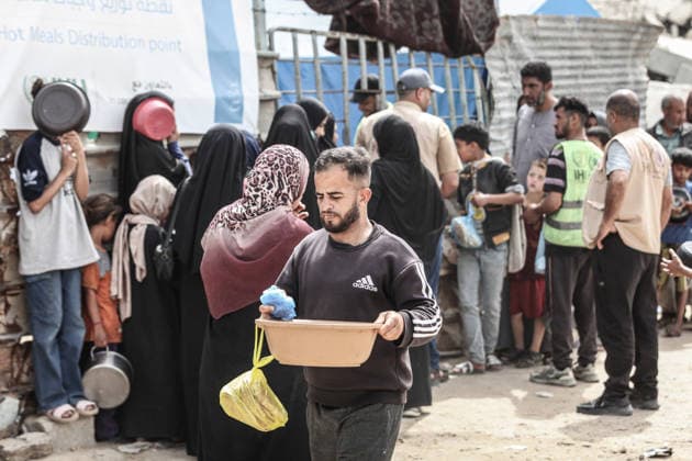 Hot meals distributed to displaced Palestinians in Gaza GAZA CITY, GAZA, PALESTINE - MAY 18: Displaced Palestinians, including many children, wait in long queues to receive hot meals distributed by a charitable organization at Bureijj Refugee Camp in Gaza City, Gaza, Palestine on May 18, 2026. Due to the ongoing Israeli blockade and severe restrictions on the entry of humanitarian aid, the region continues to face a critical food shortage, leaving thousands of families reliant on irregular aid distributions. Moiz Salhi Anadolu Gaza City Gaza. Editorial use only. Please get in touch for any other usage.  Copyright: x2026xAnadoluxMoizxSalhix
