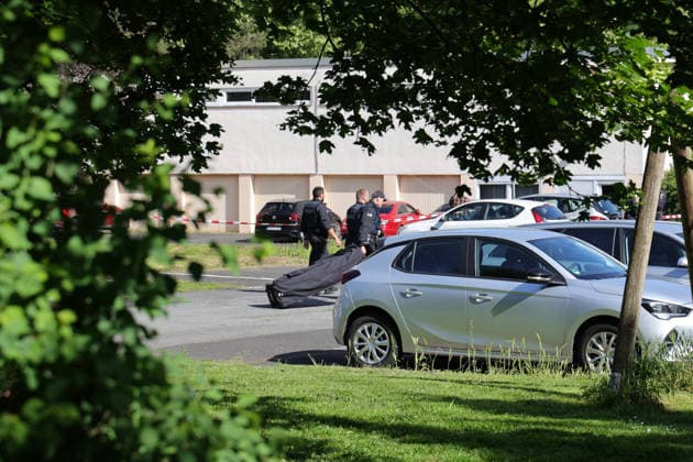 Woman found dead in front of apartment building 23-year-ol