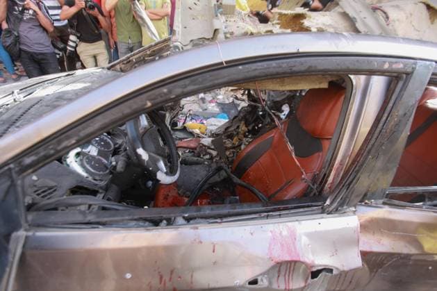 RECORD DATE NOT STATED Palestinians Inspect Damaged Vehicle After Drone Strike in Gaza City (INT) Palestinians Inspect Damaged Vehicle After Drone Strike in Gaza City. May 18, 2026, Gaza, Palestine: Palestinians inspect a civilian vehicle after it was struck by a missile fired from an Israeli drone in the Al-Rimal neighborhood in central Gaza City. Medical sources said the strike killed one person and wounded at least four others, as emergency teams transferred the casualties to nearby hospitals for treatment. Credit: Hashem Zimmo Thenews2(Foto: Hashem Zimmo Thenews2 imago images) Palestinians Inspect Damaged Vehicle After Drone Strike in Gaza City  Copyright: xHashemxZimmox