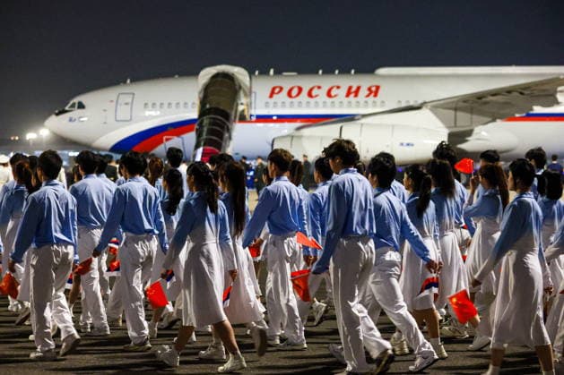 CHINA, BEIJING - MAY 19, 2026: People with Chinese and Russian flags are seen during a ceremony marking the arrival of Russia s President Putin at Beijing Capital International Airport (Shoudu). Russian President Putin s official visit to China coincides with the 25th anniversary of the Treaty of Good-Neighbourliness and Friendly Cooperation Between the People s Republic of China and the Russian Federation, which was signed on 16 July, 2001. Vladimir Smirnov TASS  92744435