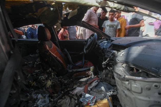 RECORD DATE NOT STATED Palestinians Inspect Damaged Vehicle After Drone Strike in Gaza City (INT) Palestinians Inspect Damaged Vehicle After Drone Strike in Gaza City. May 18, 2026, Gaza, Palestine: Palestinians inspect a civilian vehicle after it was struck by a missile fired from an Israeli drone in the Al-Rimal neighborhood in central Gaza City. Medical sources said the strike killed one person and wounded at least four others, as emergency teams transferred the casualties to nearby hospitals for treatment. Credit: Hashem Zimmo Thenews2(Foto: Hashem Zimmo Thenews2 imago images) Palestinians Inspect Damaged Vehicle After Drone Strike in Gaza City  Copyright: xHashemxZimmox