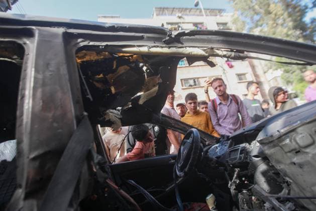 RECORD DATE NOT STATED Palestinians Inspect Damaged Vehicle After Drone Strike in Gaza City (INT) Palestinians Inspect Damaged Vehicle After Drone Strike in Gaza City. May 18, 2026, Gaza, Palestine: Palestinians inspect a civilian vehicle after it was struck by a missile fired from an Israeli drone in the Al-Rimal neighborhood in central Gaza City. Medical sources said the strike killed one person and wounded at least four others, as emergency teams transferred the casualties to nearby hospitals for treatment. Credit: Hashem Zimmo Thenews2(Foto: Hashem Zimmo Thenews2 imago images) Palestinians Inspect Damaged Vehicle After Drone Strike in Gaza City  Copyright: xHashemxZimmox