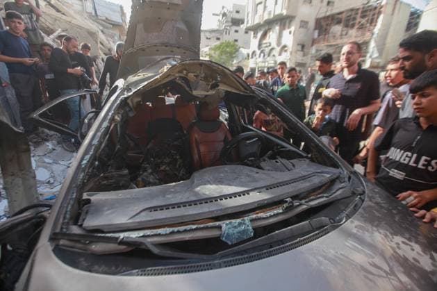 RECORD DATE NOT STATED Palestinians Inspect Damaged Vehicle After Drone Strike in Gaza City (INT) Palestinians Inspect Damaged Vehicle After Drone Strike in Gaza City. May 18, 2026, Gaza, Palestine: Palestinians inspect a civilian vehicle after it was struck by a missile fired from an Israeli drone in the Al-Rimal neighborhood in central Gaza City. Medical sources said the strike killed one person and wounded at least four others, as emergency teams transferred the casualties to nearby hospitals for treatment. Credit: Hashem Zimmo Thenews2(Foto: Hashem Zimmo Thenews2 imago images) Palestinians Inspect Damaged Vehicle After Drone Strike in Gaza City  Copyright: xHashemxZimmox