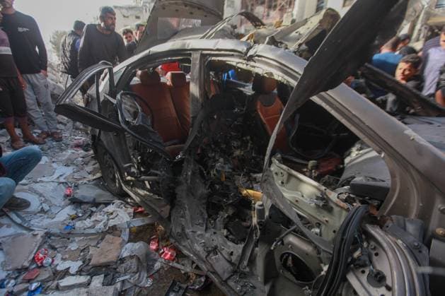 RECORD DATE NOT STATED Palestinians Inspect Damaged Vehicle After Drone Strike in Gaza City (INT) Palestinians Inspect Damaged Vehicle After Drone Strike in Gaza City. May 18, 2026, Gaza, Palestine: Palestinians inspect a civilian vehicle after it was struck by a missile fired from an Israeli drone in the Al-Rimal neighborhood in central Gaza City. Medical sources said the strike killed one person and wounded at least four others, as emergency teams transferred the casualties to nearby hospitals for treatment. Credit: Hashem Zimmo Thenews2(Foto: Hashem Zimmo Thenews2 imago images) Palestinians Inspect Damaged Vehicle After Drone Strike in Gaza City  Copyright: xHashemxZimmox