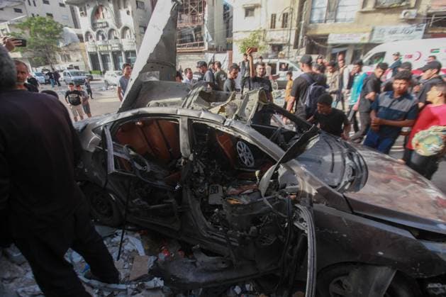 RECORD DATE NOT STATED Palestinians Inspect Damaged Vehicle After Drone Strike in Gaza City (INT) Palestinians Inspect Damaged Vehicle After Drone Strike in Gaza City. May 18, 2026, Gaza, Palestine: Palestinians inspect a civilian vehicle after it was struck by a missile fired from an Israeli drone in the Al-Rimal neighborhood in central Gaza City. Medical sources said the strike killed one person and wounded at least four others, as emergency teams transferred the casualties to nearby hospitals for treatment. Credit: Hashem Zimmo Thenews2(Foto: Hashem Zimmo Thenews2 imago images) Palestinians Inspect Damaged Vehicle After Drone Strike in Gaza City  Copyright: xHashemxZimmox