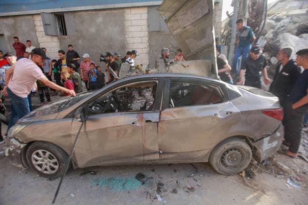 RECORD DATE NOT STATED Palestinians Inspect Damaged Vehicle After Drone Strike in Gaza City (INT) Palestinians Inspect Damaged Vehicle After Drone Strike in Gaza City. May 18, 2026, Gaza, Palestine: Palestinians inspect a civilian vehicle after it was struck by a missile fired from an Israeli drone in the Al-Rimal neighborhood in central Gaza City. Medical sources said the strike killed one person and wounded at least four others, as emergency teams transferred the casualties to nearby hospitals for treatment. Credit: Hashem Zimmo Thenews2(Foto: Hashem Zimmo Thenews2 imago images) Palestinians Inspect Damaged Vehicle After Drone Strike in Gaza City  Copyright: xHashemxZimmox