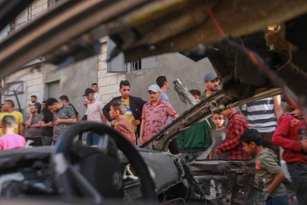 RECORD DATE NOT STATED Palestinians Inspect Damaged Vehicle After Drone Strike in Gaza City (INT) Palestinians Inspect Damaged Vehicle After Drone Strike in Gaza City. May 18, 2026, Gaza, Palestine: Palestinians inspect a civilian vehicle after it was struck by a missile fired from an Israeli drone in the Al-Rimal neighborhood in central Gaza City. Medical sources said the strike killed one person and wounded at least four others, as emergency teams transferred the casualties to nearby hospitals for treatment. Credit: Hashem Zimmo Thenews2(Foto: Hashem Zimmo Thenews2 imago images) Palestinians Inspect Damaged Vehicle After Drone Strike in Gaza City  Copyright: xHashemxZimmox