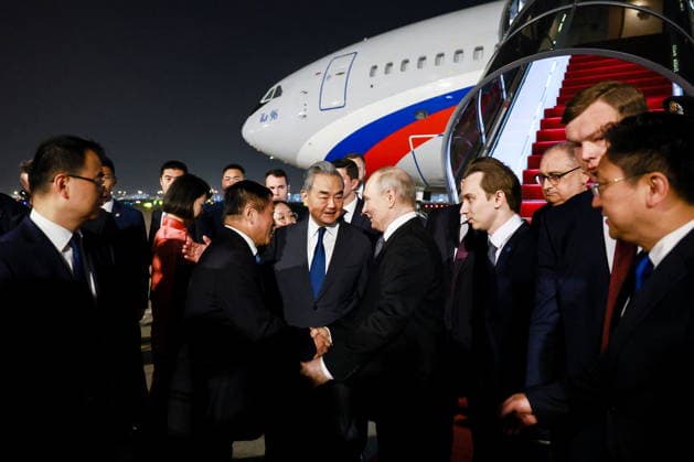 CHINA, BEIJING - MAY 19, 2026: China s Minister of Foreign Affairs Wang Yi (C) and Russia s President Vladimir Putin (5th R) during a ceremony marking Putin s arrival at Beijing Capital International Airport (Shoudu). Russian President Putin s official visit to China coincides with the 25th anniversary of the Treaty of Good-Neighbourliness and Friendly Cooperation Between the People s Republic of China and the Russian Federation, which was signed on 16 July, 2001. Vladimir Smirnov TASS  92744891