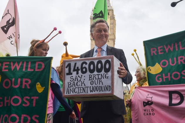 May 19, 2026, London, England, United Kingdom: ANDREW GEORGE, Liberal Democrat MP for St Ives, holds a petition box in Parliament Square during the march for ancient woodland restoration. Organised by the campaign group Wild Card, the protesters marched to the Department for Environment, Food and Rural Affairs (DEFRA) calling on the government to restore so-called ghost woods , remains of ancient ecosystems buried beneath timber plantations. London United Kingdom - ZUMAv130 20260519_zip_v130_054 Copyright: xVukxValcicx