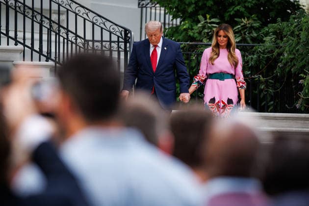 U.S. President Donald Trump and First Lady Melania Trump walk down the stairs to the South Lawn of the White House to greet guests during the Congressional Picnic on the South Lawn of the White House on May 19, 2026 in Washington, DC.  WAX20260519845 SamuelxCorum