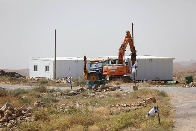 Illegal Israeli settlers expand outpost in West Bank s Umm al-Khair HEBRON, WEST BANK, PALESTINE - MAY 20: Prefabricated houses installed by illegal Israeli settlers are seen under the protection of the Israeli army in the village of Umm al-Khair, located in the Masafer Yatta region south of Hebron in West Bank, Palestine on May 20, 2026. Illegal settlers continue to expand a newly established settlement outpost, seizing Palestinian lands in the area. Wisam Hashlamoun Anadolu Hebron West Bank. Editorial use only. Please get in touch for any other usage.  Copyright: x2026xAnadoluxWisamxHashlamounx