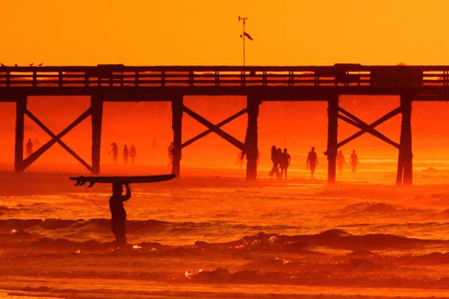 May 20, 2026, Isle Of Palms, Sc, United States: A surfer silhouetted by the sunrise carries his board out into deeper water on Front Beach, May 20, 2026 in Isle of Palms, South Carolina. Isle Of Palms United States - ZUMAe02_ 20260520_zaf_e02_005 Copyright: xRichardxEllisx
