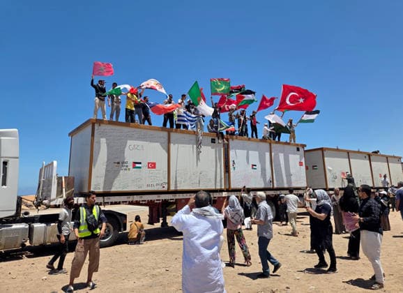 Global Sumud Flotilla convoy wait near Sirte for 4 days to cross into eastern Libya SIRTE, LIBYA - MAY 20: People wave flags of Turkiye, Palestine, Morocco as Global Sumud Flotilla convoy, which set out by land to break the blockade on Gaza and deliver humanitarian aid, continues to wait near Libya s Sirte for 4 days on May 20, 2026. Stringer Anadolu Sirte Libya. Editorial use only. Please get in touch for any other usage.  Copyright: x2026xAnadoluxStringerx