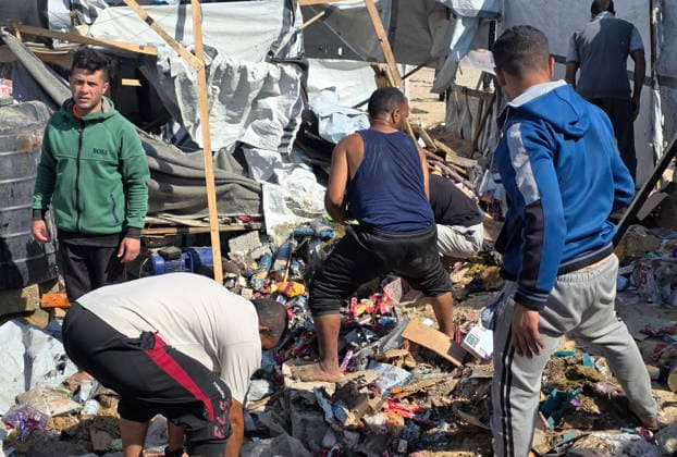 Palestinian Rescue Teams Inspect Site of Israeli Strike in Khan Younis Palestinian paramedics, civil defense crews and residents inspect the site of an Israeli airstrike that targeted a tent sheltering displaced people in the Mawasi area of Khan Younis in the southern Gaza Strip, on May 21, 2026. According to local sources, the strike wounded several displaced Palestinians, sparked a fire in the targeted tent and caused extensive damage to nearby tents. Photo by Tariq Mohammad APA Images Khan Yunis Gaza Strip Palestinian Territory 210526_Khan_Yunis_TM_02(14) Copyright: xapaimagesxTariqxMohammad xapaimagesx