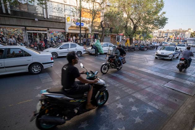 Daily Life In Iran Amid Threat About New Possible War Motorcyclists ride over U.S. and Israeli flags in a business district in downtown Tehran, Iran, on May 22, 2026. U.S. President Donald Trump has threatened Iran with the possibility of a new conflict, and according to official reports, he is considering military action if no agreement is reached with Iranian officials. Tehran Tehran Iran  Copyright: xMortezaxNikoubazlx originalFilename: nikoubazl-dailylif260522_npb6O