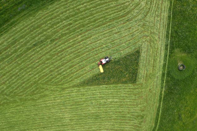 Aerial view spring spring in Siegerland A lush green meadow is mowed by a tractor with a mower mower near Siegen Oberschelden spring spring in Siegerland on 23 05 2026 in Siegen Germany