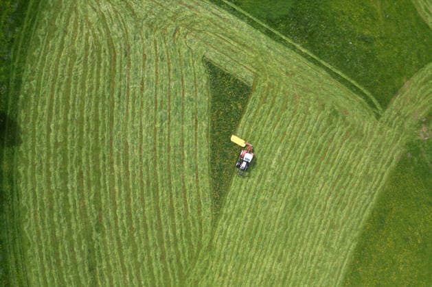 Aerial view spring spring in Siegerland A lush green meadow is mowed by a tractor with a mower mower near Siegen Oberschelden spring spring in Siegerland on 23 05 2026 in Siegen Germany
