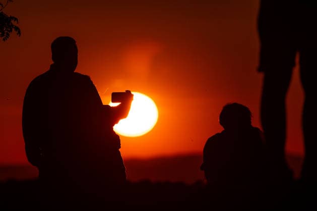 Warm May weather in the Taunus People watching the sunset from the Großer Feldberg in the Taunus , Schmitten Hessen Germany