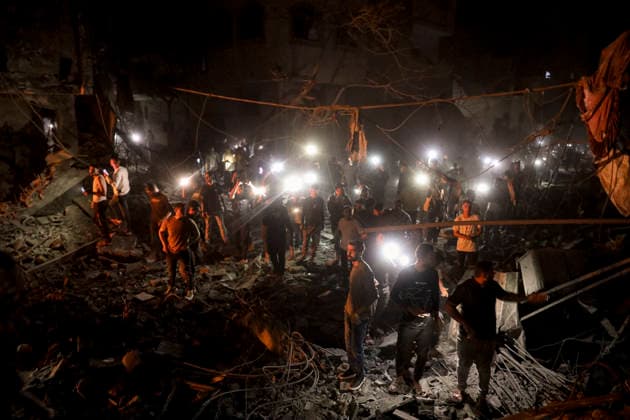 Nuseirat Homes Destroyed Airstrike May 25 Palestinian residents gather as fire billows from a damaged building following an Israeli airstrike in Nuseirat in the central Gaza Strip on May 25, 2026. It was reported that five houses were destroyed and dozens more damaged in the strikes. Nuseirat Gaza Strip Palestinian Territories Copyright: xAhmedxYounisx
