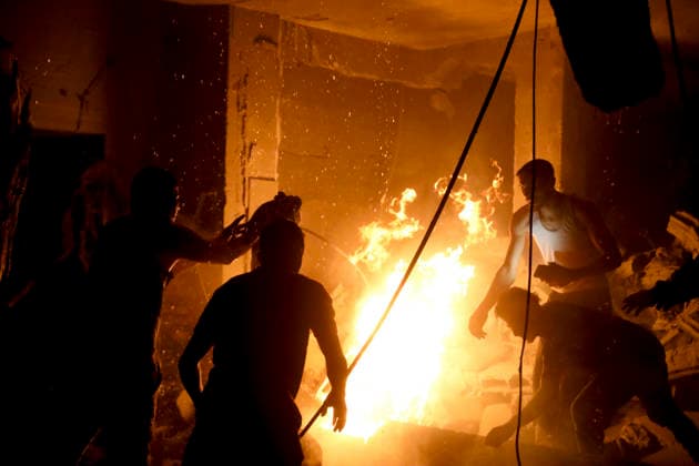 Nuseirat Homes Destroyed Airstrike May 25 Palestinian residents gather to extinguish a fire in a building following an Israeli airstrike in Nuseirat in the central Gaza Strip on May 25, 2026. It was reported that five houses were destroyed and dozens more damaged in the strikes. Nuseirat Gaza Strip Palestinian Territories Copyright: xAhmedxYounisx