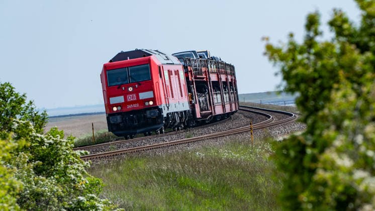 Sylt Shuttle train, operated by DB Regio, pulled by a TRAXX P160 DE ME class 245 diesel-electric TRAXX multi-engine locomotive from DB Regio Autozug on the Marschbahn line on the North Sea island of Sylt, Sylt Schleswig Holstein Germany Hindenburgdamm, Marschbahn