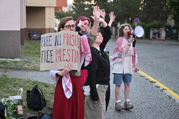 The situation in front of the District Court in Pardubice, where a custody hearing is underway with a man accused of intentionally setting fire to the LPP Holding hall, 28 May 2026, Pardubice, Czech Republic. Several supporters, including girls, came to support the detainee in front of the court building with Palestinian scarves and banners. Criminal investigators are accusing him of the crime of a terrorist attack and participation in a terrorist group. According to earlier reports, police have detained ten people in connection with this case. A fire broke out on March 20 in the production hall of the LPP Holding arms factory in Pardubice. The Earthquake Faction alleged anti-Israel group claimed responsibility for the fire. The group state  CTKPhotoP2026052809186