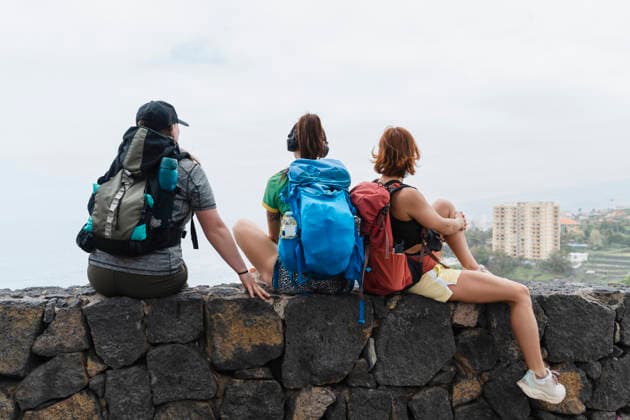 Hikers resting on coastal wall looking at view in Tenerife Spain model released, Symbolfoto, NDEF03257