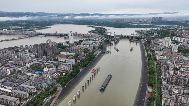 (260608) -- YICHANG, June 8, 2026 -- An aerial drone photo taken on June 8, 2026 shows the upgrading site of navigation facilities at Gezhouba in Yichang, central China s Hubei Province. China on Monday began construction of a mega waterway project, including what is expected to become the world s largest inland ship lock, in response to the rising shipping demand along the Yangtze, the world s third-longest river. The 77.2-billion-yuan (about 11.3 billion U.S. dollars) project will add a five-tier, dual-track ship lock north of the existing lock at the Three Gorges Dam, the world s largest water conservancy project, and upgrade navigation facilities at a smaller downstream dam. The new ship lock and its approach channels, which toge