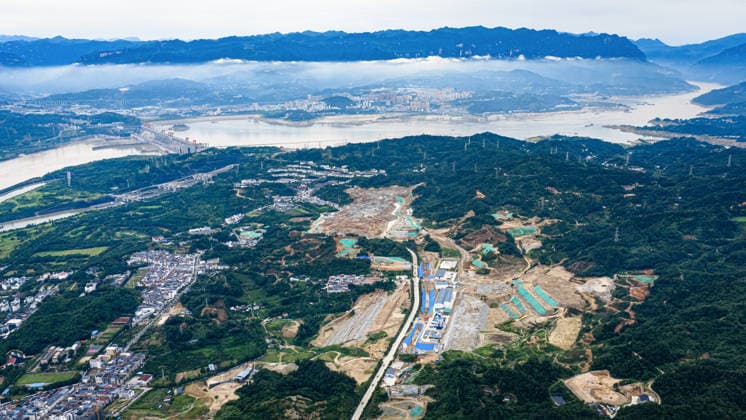 (260608) -- YICHANG, June 8, 2026 -- An aerial drone photo taken on June 8, 2026 shows the construction site of a new ship lock and its approach channels of the Three Gorges new waterway project in Yichang, central China s Hubei Province. China on Monday began construction of a mega waterway project, including what is expected to become the world s largest inland ship lock, in response to the rising shipping demand along the Yangtze, the world s third-longest river. The 77.2-billion-yuan (about 11.3 billion U.S. dollars) project will add a five-tier, dual-track ship lock north of the existing lock at the Three Gorges Dam, the world s largest water conservancy project, and upgrade navigation facilities at a smaller downstream dam. The