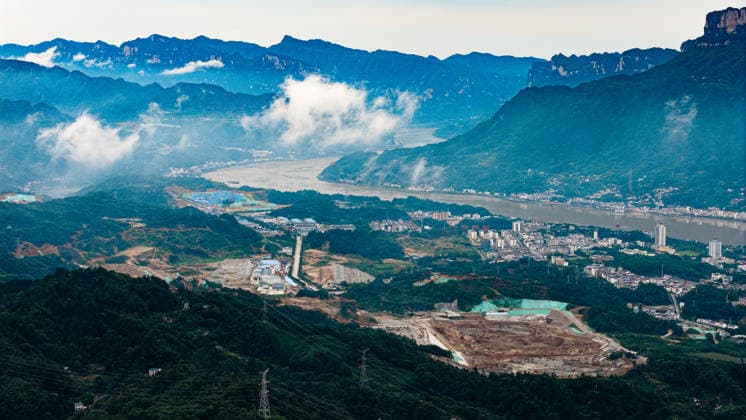 (260608) -- YICHANG, June 8, 2026 -- An aerial drone photo taken on June 8, 2026 shows the construction site of a new ship lock and its approach channels of the Three Gorges new waterway project in Yichang, central China s Hubei Province. China on Monday began construction of a mega waterway project, including what is expected to become the world s largest inland ship lock, in response to the rising shipping demand along the Yangtze, the world s third-longest river. The 77.2-billion-yuan (about 11.3 billion U.S. dollars) project will add a five-tier, dual-track ship lock north of the existing lock at the Three Gorges Dam, the world s largest water conservancy project, and upgrade navigation facilities at a smaller downstream dam. The