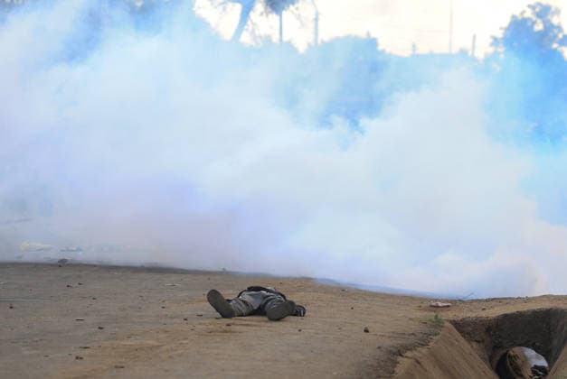 Protest held in Kenya against planned U.S. Ebola quarantine facility NANYUKI, KENYA - JUNE 09: A protester collapses to the ground after being injured in the head as Kenyan police use water cannons and tear gas against demonstrators in Nanyuki, central Kenya on June 09, 2026. Dozens gathered to protest a planned Ebola quarantine facility for U.S. citizens, blocking a road and setting fires before police intervened. Lucas Mukasa Anadolu Nanyuki Kenya. Editorial use only. Please get in touch for any other usage.  Copyright: x2026xAnadoluxLucasxMukasax