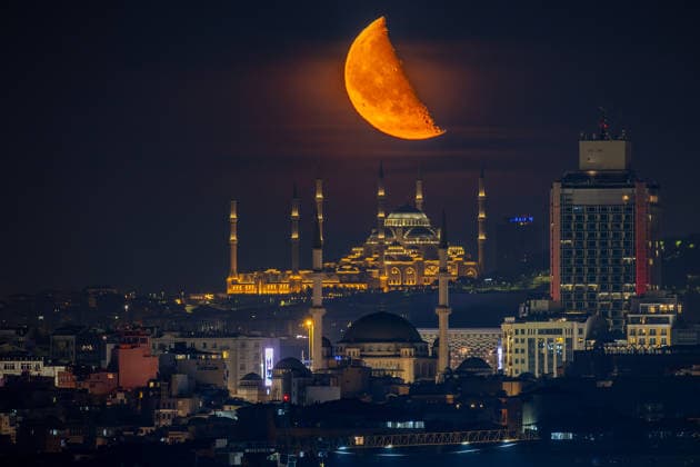 The moon rises over Taksim Mosque and Camlica Mosque, creating a striking view above the city skyline in Istanbul, Türkiye, Tuesday, June 9, 2026. (Melih Bagci - Depo Photos) Copyright: MelihxBagcix-xDepoxPhotos 19125890