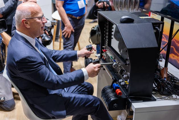 Press tour at the ILA Berlin 2026, Berlin, 09 06 2026 Kai Wegner, Governing Mayor of Berlin CDU , operates the control sticks of a flight simulator Accompanied by press photographers and trade fair visitors 20260609-286A9071-M4000