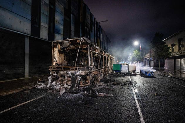 June 9, 2026, Belfast, Antrim, United Kingdom: A burnt out bus seen after an anti-immigration protest. Belfast erupted into flames as locals took to the streets to protest against the stabbing of a North Belfast man by a Sudanese national refugee. Road blockades were set up all over Belfast bringing much of the city to a standstill. The protestors are demanding a stop to immigration into Northern Ireland. Belfast United Kingdom  - ZUMAs197 20260609_aaa_s197_275 Copyright: xLabxMox