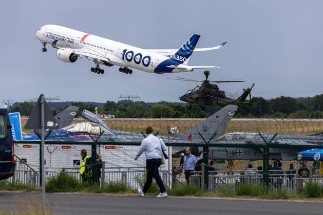 Trade visitor day at ILA Berlin 2026, Berlin, 12 06 2026 An Airbus A350 1000 in the Airbus house livery takes off at the flight display In the background you can see a Eurocopter Tiger combat helicopter of the German Armed Forces and a fighter aircraft on display with Bundeswehr identification 14 92 Schöneberg Berlin ExpoCenter Airport Brandenburg Germany 20260612-1V9A1729-M4000