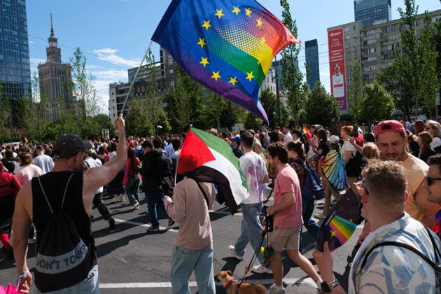 June 13, 2026, Warsaw, Masovian Voivodeship, Poland: A person holds up a rainbow EU flag as another person holds a Palestinian flag during the 25th annual Warsaw LGBTQ+ Pride Parade, known in Polish as the Equality Parade. LGBTQ+ people in Poland do not have the right to same-sex civil partnerships, marriage, and child adoption, while also facing homophobia and queerphobia from a largely conservative society. Therefore, the parade is organized primarily as a march for equal rights. Warsaw Poland - ZUMAk204 20260613_zip_k204_028 Copyright: xRomanxKozielx