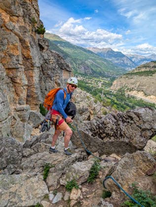 Climbing in Casse de Prelles,detected_source_language in the French Alps a Person with Climbing equipment at a rocky Mountain trail Alps Mountain panorama at a blue Sky 1133302996 ,model released, Symbolfoto