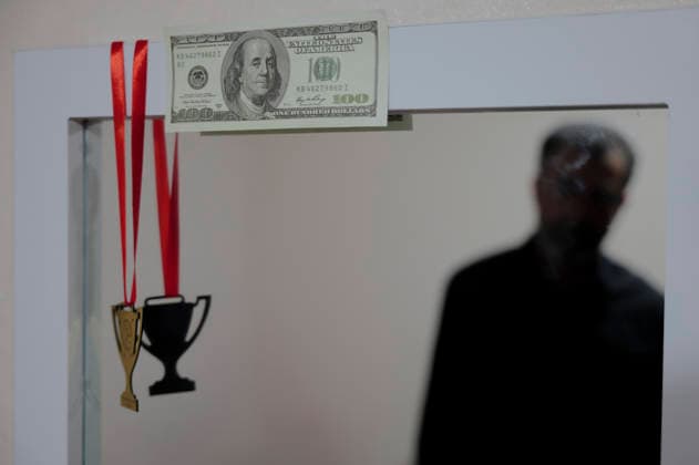 Iran Lamerd Sports Facility Missile Strikes Aftermath A man is reflected in a mirror displaying a United States hundred-dollar bill and a hanging medal in Lamerd, Fars Province, Iran, on June 4, 2026. On February 28, 2026, a two-missile strike hit a local sports hall while a women s volleyball team used the facility, killing at least 21 people and injuring around 100 others. Independent investigations concluded a United States Precision Strike Missile was used in the attack, though the United States Central Command denied responsibility. Lamerd Fars Iran Copyright: xLaurinxStrelex