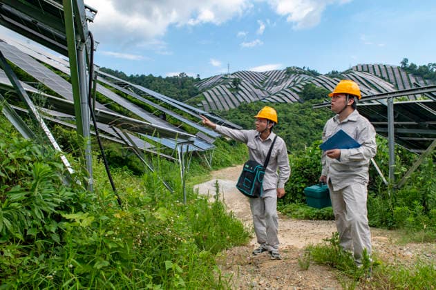 JINHUA, CHINA - JULY 16: Staff members inspect the operation of photovoltaic panels at an agrivoltaic power generation project on July 16, 2026 in Jinhua, Zhejiang Province of China. The project combines agricultural production with photovoltaic power generation to utilize land resources.  Copyright: xVCGx 111654625888