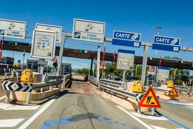 View from a vehicle of the entrance to a highway toll plaza in Italy At a toll plaza in Italy