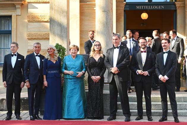 From left: Joachim SAUER, Michel FRIEDMANN, Karin BAUMUELLER SOEDER, Angela MERKEL, Katharina WAGNER, Markus SOEDER, Minister-President of Bavaria and CSU Chairman, Mayor Andreas ZIPPEL and his partner, opening of the 2026 Bayreuth Richard Wagner Festival, Red carpet on July 25, 2026, at the Green Hill,