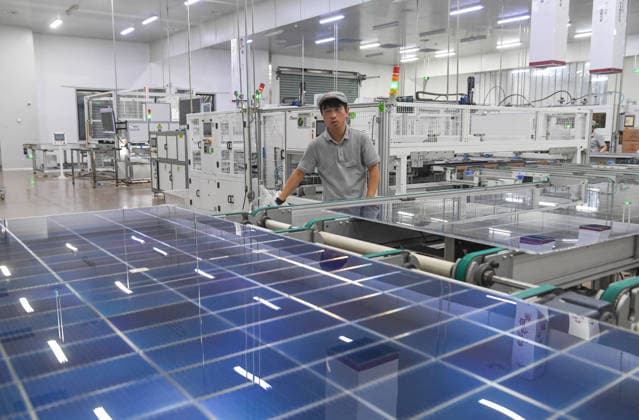 JINHUA, CHINA - JULY 28: Workers produce solar photovoltaic modules at the intelligent manufacturing workshop of Runma Guangneng Technology (Jinhua) Co., Ltd. on July 28, 2026 in Jinhua, Zhejiang Province of China. The company is rushing to fulfill orders for solar photovoltaic components.  Copyright: xVCGx 111656849577