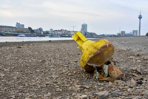 ABB RHINE Yellow Channel Marker Buoy Lying on the Bottom of the Rhine in the Dry Channel of the Rhine at Low Water Level on the Rhine Bank, near Düsseldorf-Oberkassel. Currently, shipping traffic on the Rhine ne