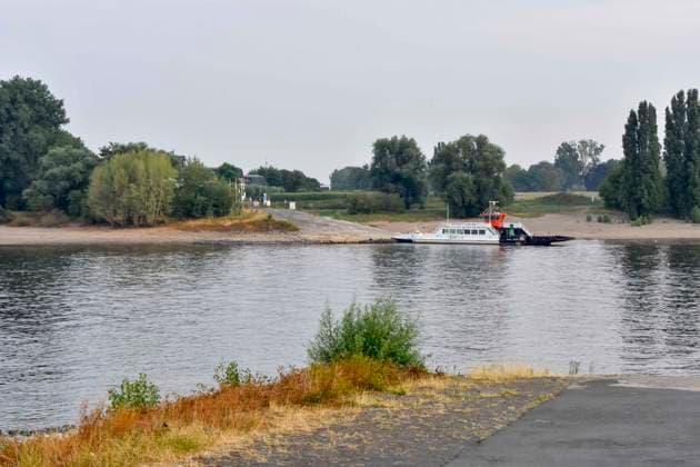 ABB RHINE Uber Boat Ferry Michaela II at the dock in the Rhine channel, low water level, Rhine riverbank, near Düsseldorf-Oberkassel. Currently, limited boat traffic on the Rhine near Oberkassel. Rhine bridge; inland waterway vessels, cargo