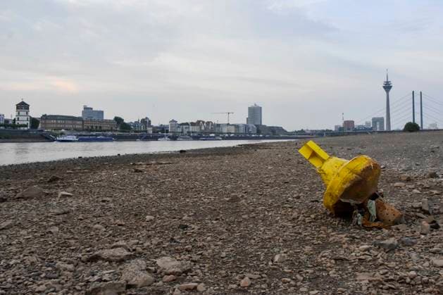 ABB RHINE Yellow Channel Marker Buoy Lying on the Bottom of the Rhine in the Dry Channel of the Rhine at Low Water Level on the Rhine Bank, near Düsseldorf-Oberkassel. Currently, shipping traffic on the Rhine ne