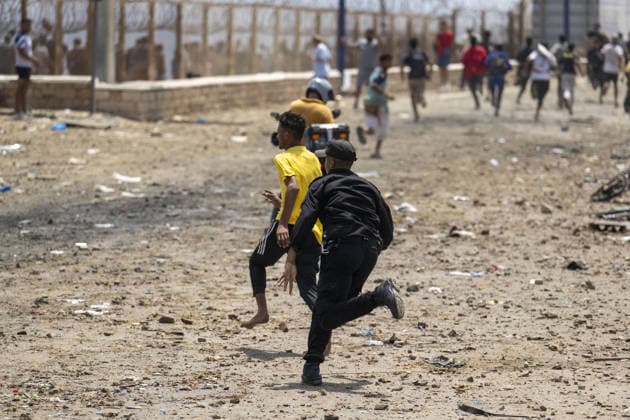 Spain says over 48,300 migrants have returned to Morocco from Ceuta CEUTA, SPAIN - JULY 31: Undocumented migrants, mostly young men, who entered Spain s North African enclave of Ceuta illegally, begin returning to Morocco after realizing their chances of obtaining legal status in Spain are unlikely on July 31, 2026. Meanwhile, small groups of migrants continue trying to cross into Ceuta by swimming or climbing the breakwater surrounding the Fnideq coast. More than 48,300 of the approximately 50,000 migrants who entered the Spanish enclave of Ceuta since early Thursday have returned to Morocco by Friday afternoon, Spain s Interior Ministry said, according to EFE news agency. Abu Adem Muhammed Anadolu Ceuta Spain. Editorial use only. Please  Copyright: x2026xAnadoluxAbuxAdemxMuhammedx