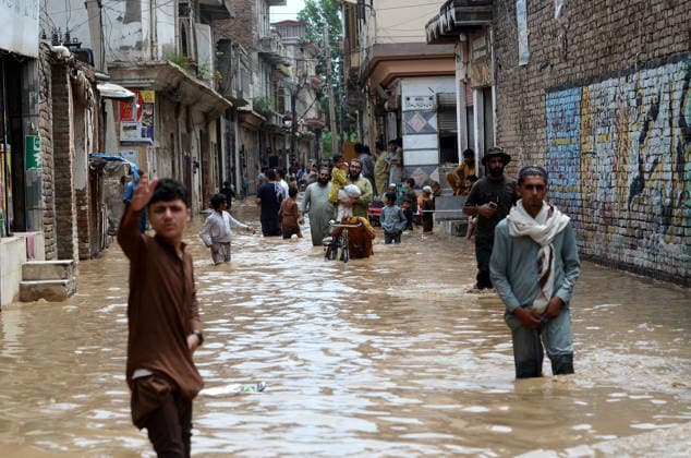 July 31, 2026, Peshawar, Peshawar, Pakistan: Residents wade through flooded street as monsoon rains inundate Peshawar..People wade through a flooded street during heavy monsoon rain in Peshawar, Khyber Pakhtunkhwa province, Pakistan, on July 31, 2026. Pakistan s Meteorological Department (PMD) forecast the current monsoon spell to continue until August 5, warning of widespread rain, thunderstorms, heavy to very heavy downpours, and the risk of urban flooding, flash floods, landslides and river flooding across parts of the country. Peshawar Pakistan - ZUMAa217 20260731_znp_a217_008 Copyright: xHussainxAlix