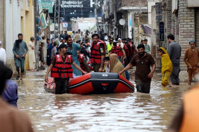 July 31, 2026, Peshawar, Peshawar, Pakistan: Residents wade through flooded street as monsoon rains inundate Peshawar..People wade through a flooded street during heavy monsoon rain in Peshawar, Khyber Pakhtunkhwa province, Pakistan, on July 31, 2026. Pakistan s Meteorological Department (PMD) forecast the current monsoon spell to continue until August 5, warning of widespread rain, thunderstorms, heavy to very heavy downpours, and the risk of urban flooding, flash floods, landslides and river flooding across parts of the country. Peshawar Pakistan - ZUMAa217 20260731_znp_a217_013 Copyright: xHussainxAlix