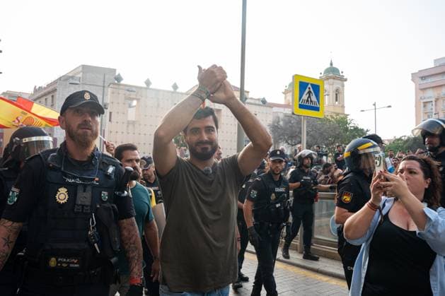 August 1, 2026, Ceuta, Spain: Spanish politician, social media influencer, and Member of the European Parliament. LUIS ALVISE PEREZ FERNÃNDEZ, 36, in Ceuta as police escort him out. Perez leads the anti-establishment and populist party Se Acabo la Fiesta (SALF), which translates to The Party Is Over. Gained prominence through guerrilla digital campaigns and anti-corruption messaging. Demonstrators gather in Ceuta to protest against far-right groups following calls for an anti-immigration rally after the arrival of tens of thousands of migrants. Authorities blocked the entry of members of the group Nucleo Nacional. Ceuta Spain - ZUMAq101 20260801_zna_q101_214 Copyright: xMarioxMorenox