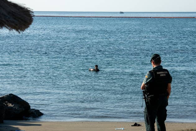 August 2, 2026, Ceuta, Madrid, Spain: A migrant attempts to swim across the border under the watchful eye of the Spanish Civil Guard at El Tarajal beach in Ceuta, Spain, August 2, 2026. Ceuta Spain - ZUMAd308 20260802_zsp_d308_007 Copyright: xJuanxCarlosxLucasx